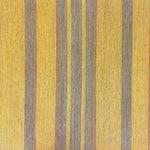 Detail of wallpaper in an irregular stripe print in shades of brown, yellow and coral.