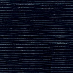 printed cotton fabric in a broken stripe pattern in white on an indigo field.