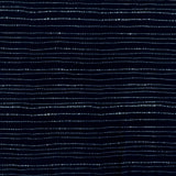 printed cotton fabric in a broken stripe pattern in white on an indigo field.