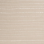 Detail of cotton fabric in a broken stripe pattern in white on a beige field.