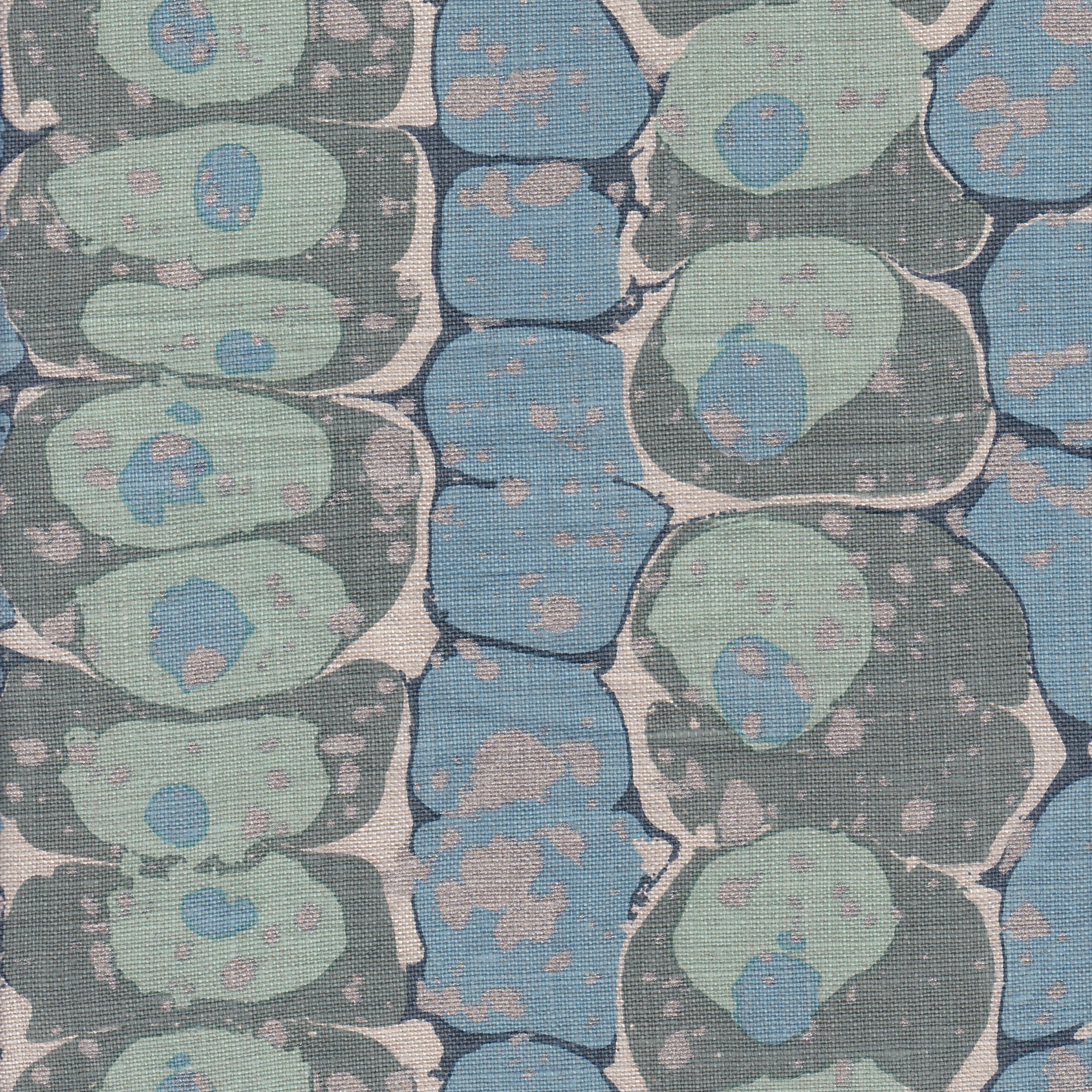 Detail of fabric in a marbled paint print in shades of blue, sage and gray.