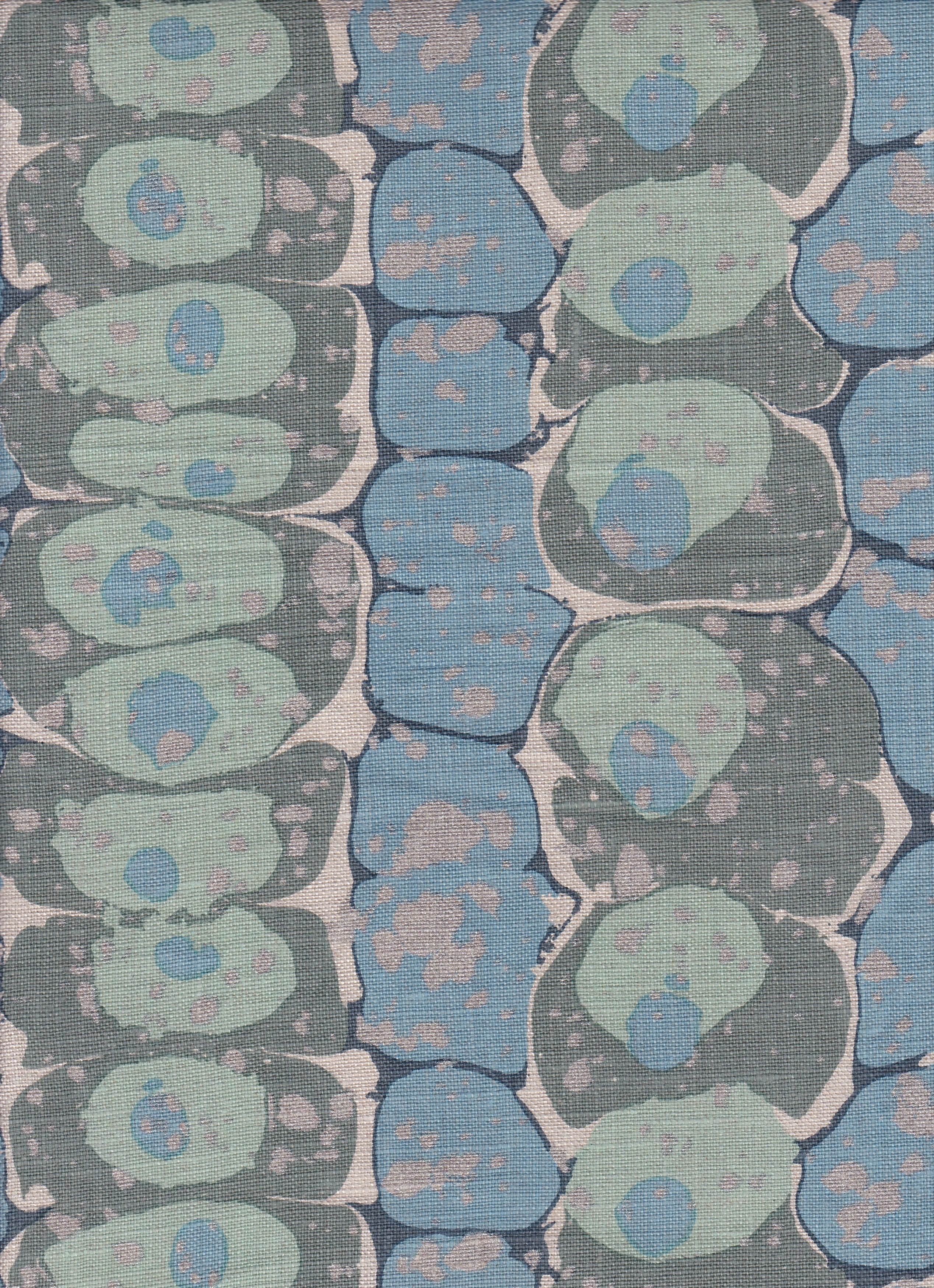 Detail of fabric in a marbled paint print in shades of blue, sage and gray.