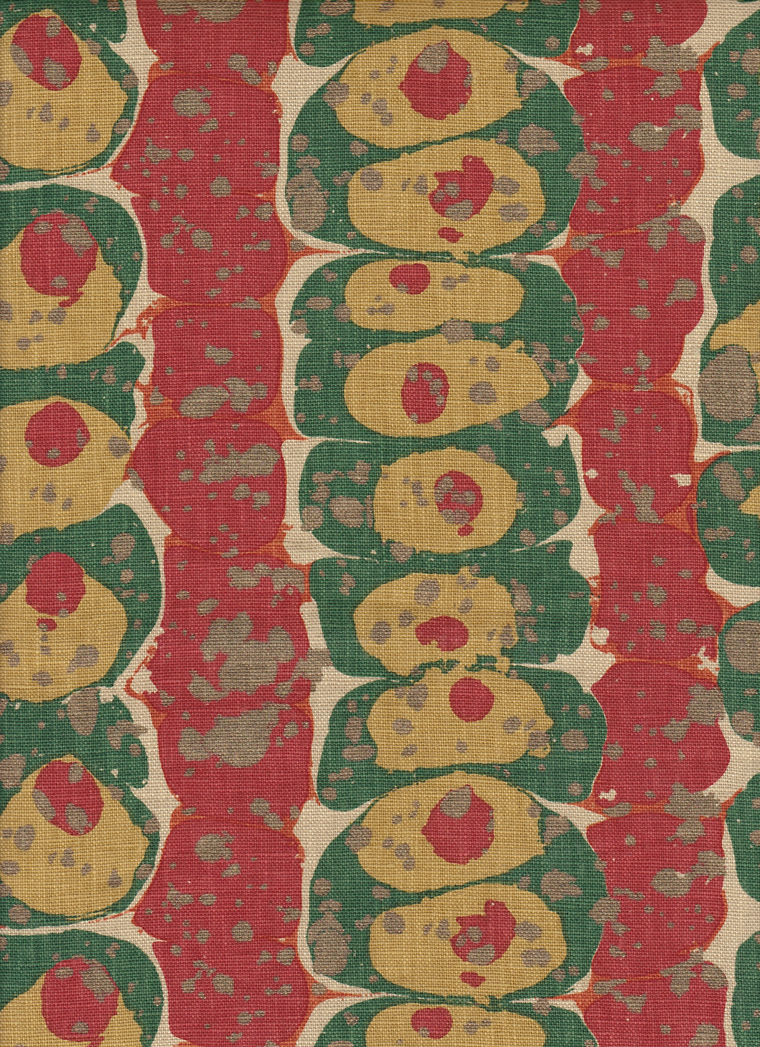 Detail of fabric in a marbled paint print in shades of red, green and gold.