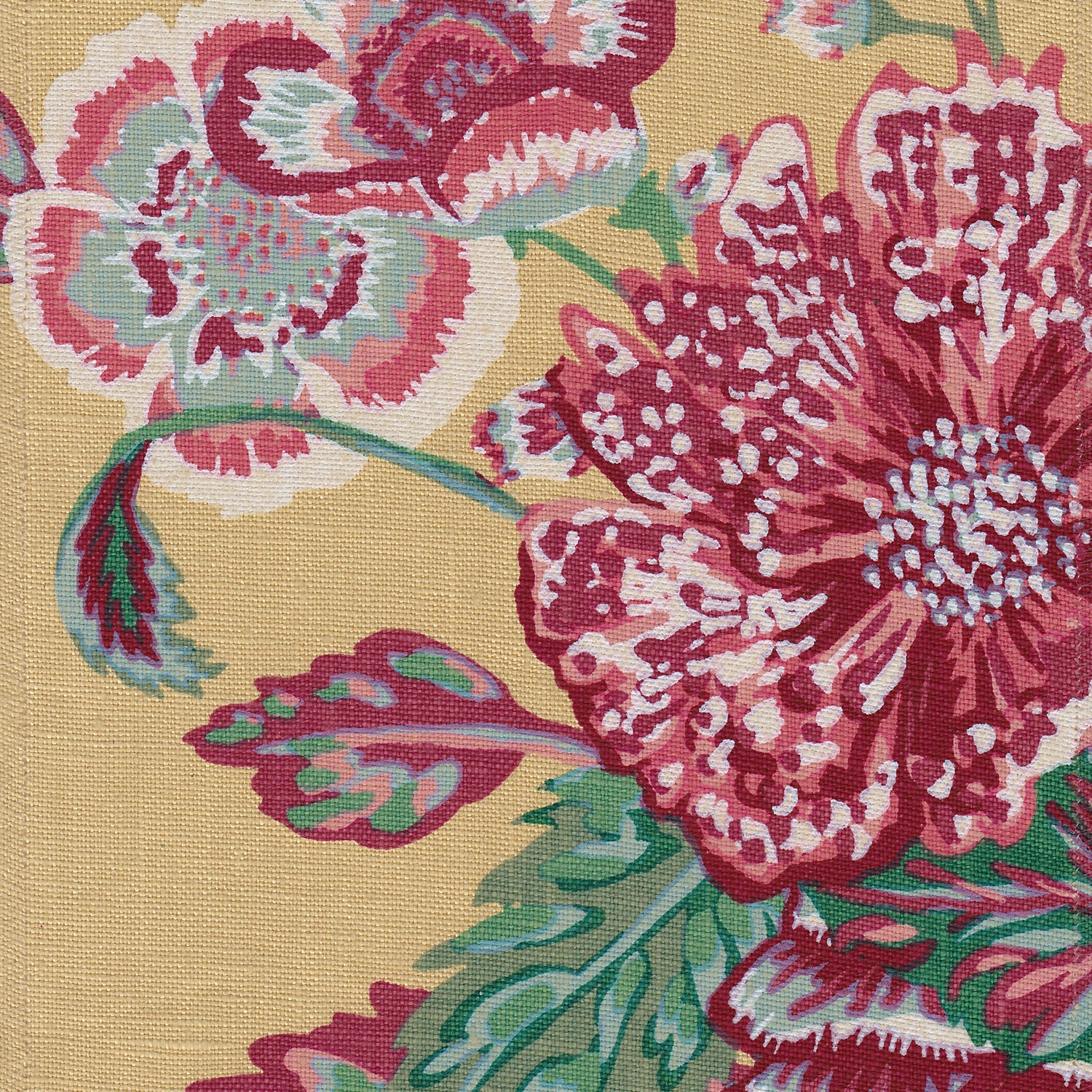 Detail of fabric in a floral print in shades of red, pink and green on a light yellow field.