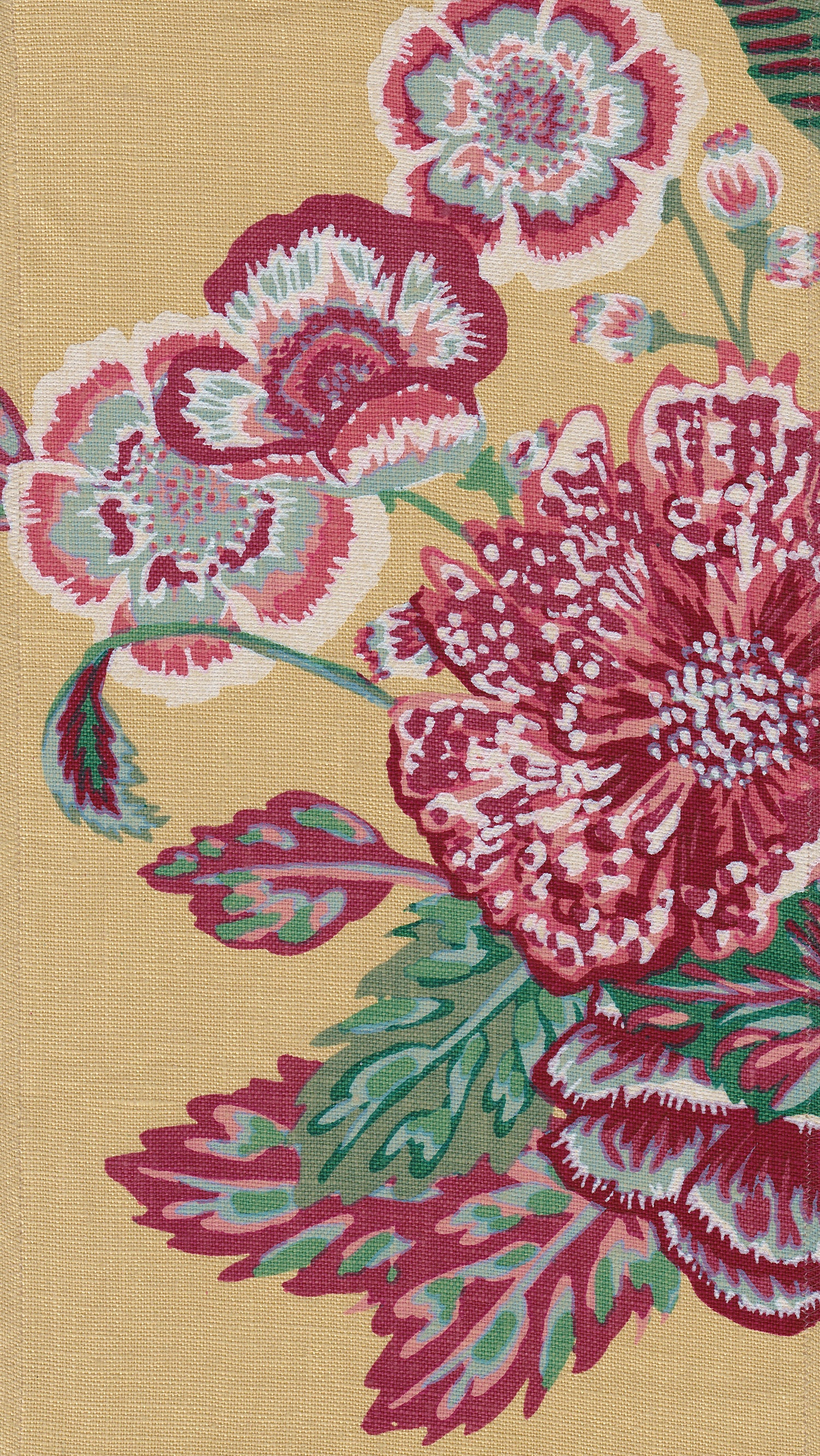 Detail of fabric in a floral print in shades of red, pink and green on a light yellow field.