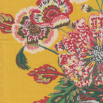 Detail of fabric in a floral print in shades of red, pink and green on a yellow field.