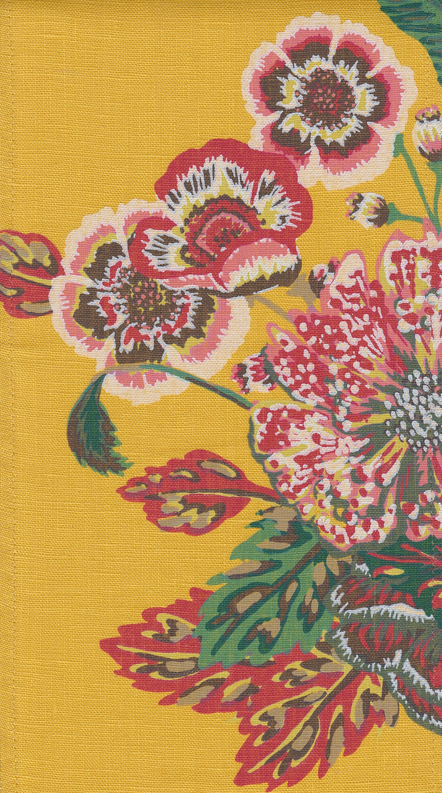 Detail of fabric in a floral print in shades of red, pink and green on a yellow field.