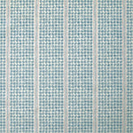 Detail of fabric in a dense repeating stripe and star print in blue on a cream field.