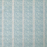 Detail of fabric in a dense repeating stripe and star print in blue on a cream field.