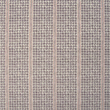 Detail of fabric in a dense repeating stripe and star print in purple on a tan field.