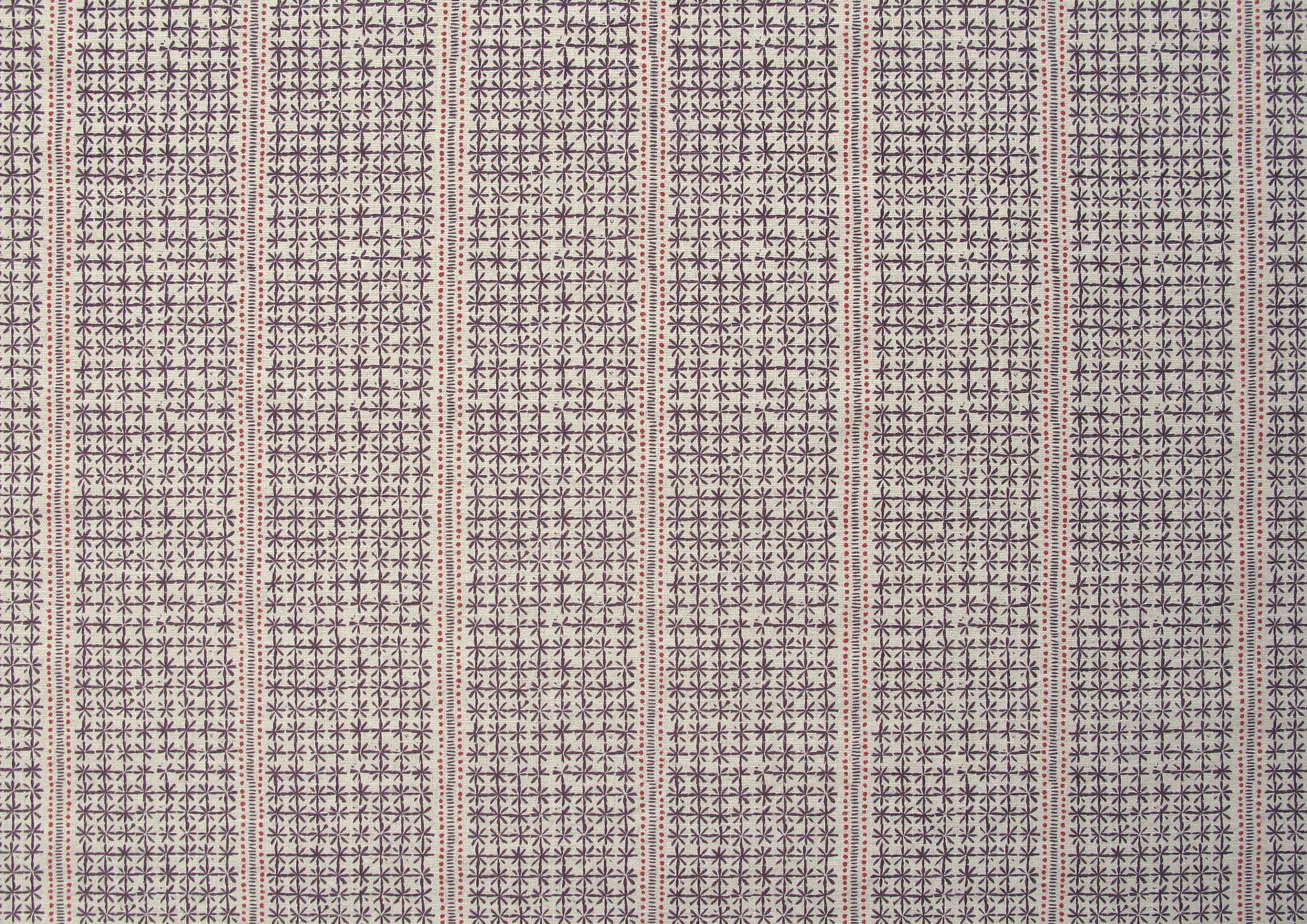 Detail of fabric in a dense repeating stripe and star print in purple on a tan field.