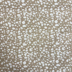 Patterned fabric with white speckles on a beige background