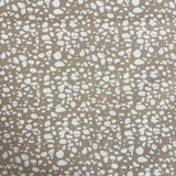 Patterned fabric with white speckles on a beige background