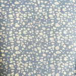 Patterned fabric with white spots on a blue background