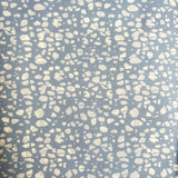Patterned fabric with white spots on a blue background