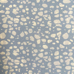 Patterned fabric with beige spots on a blue background