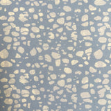 Patterned fabric with beige spots on a blue background