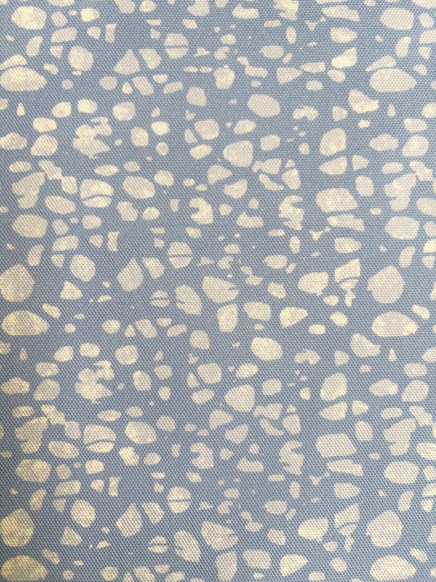 Patterned fabric with beige spots on a blue background