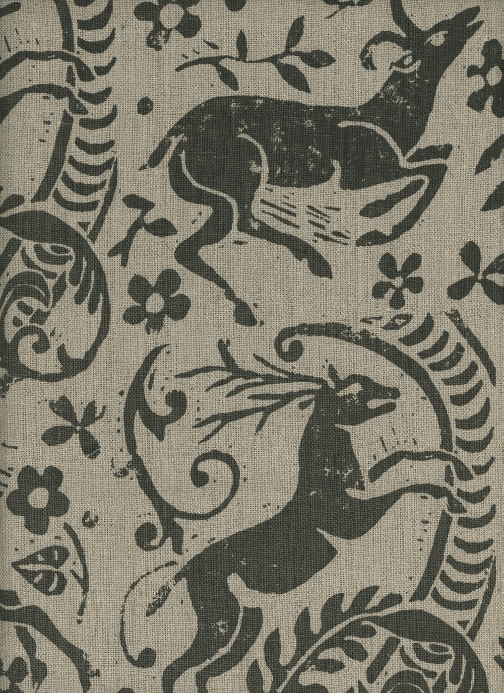 Close-up of fabric in a deer, leaf and flower print in gray on a tan field.