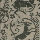 Close-up of fabric in a deer, leaf and flower print in gray on a tan field.