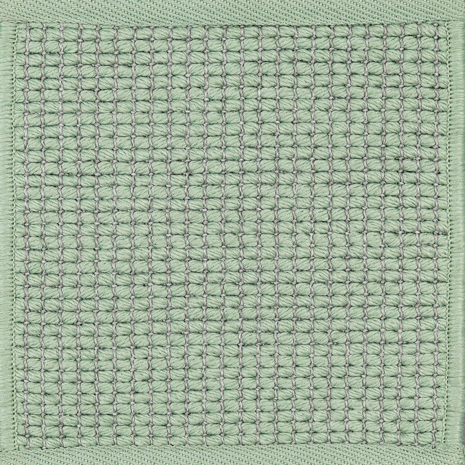 Textured woven outdoor carpet in sea foam green.