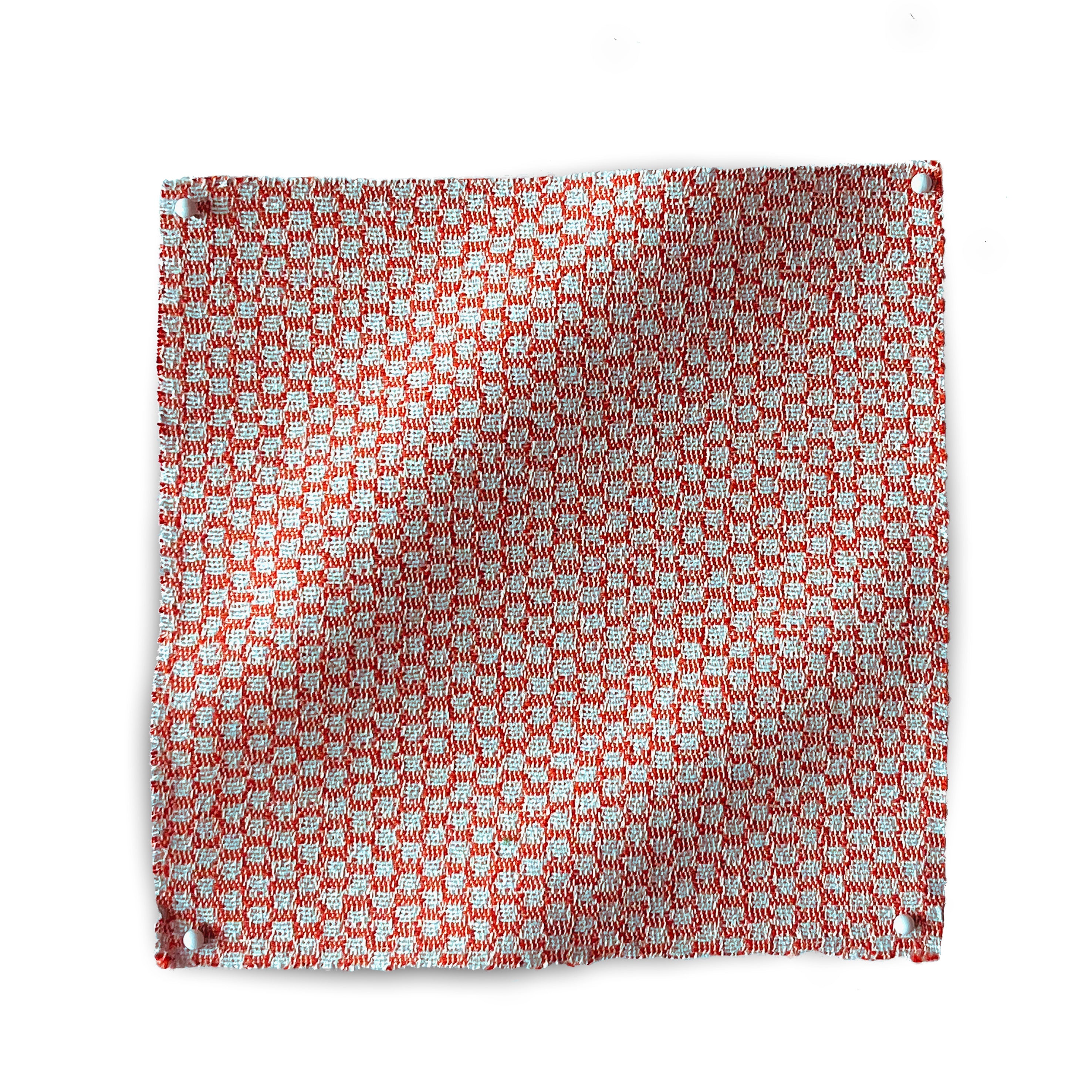 Square fabric swatch in a dense checked weave in red and white.