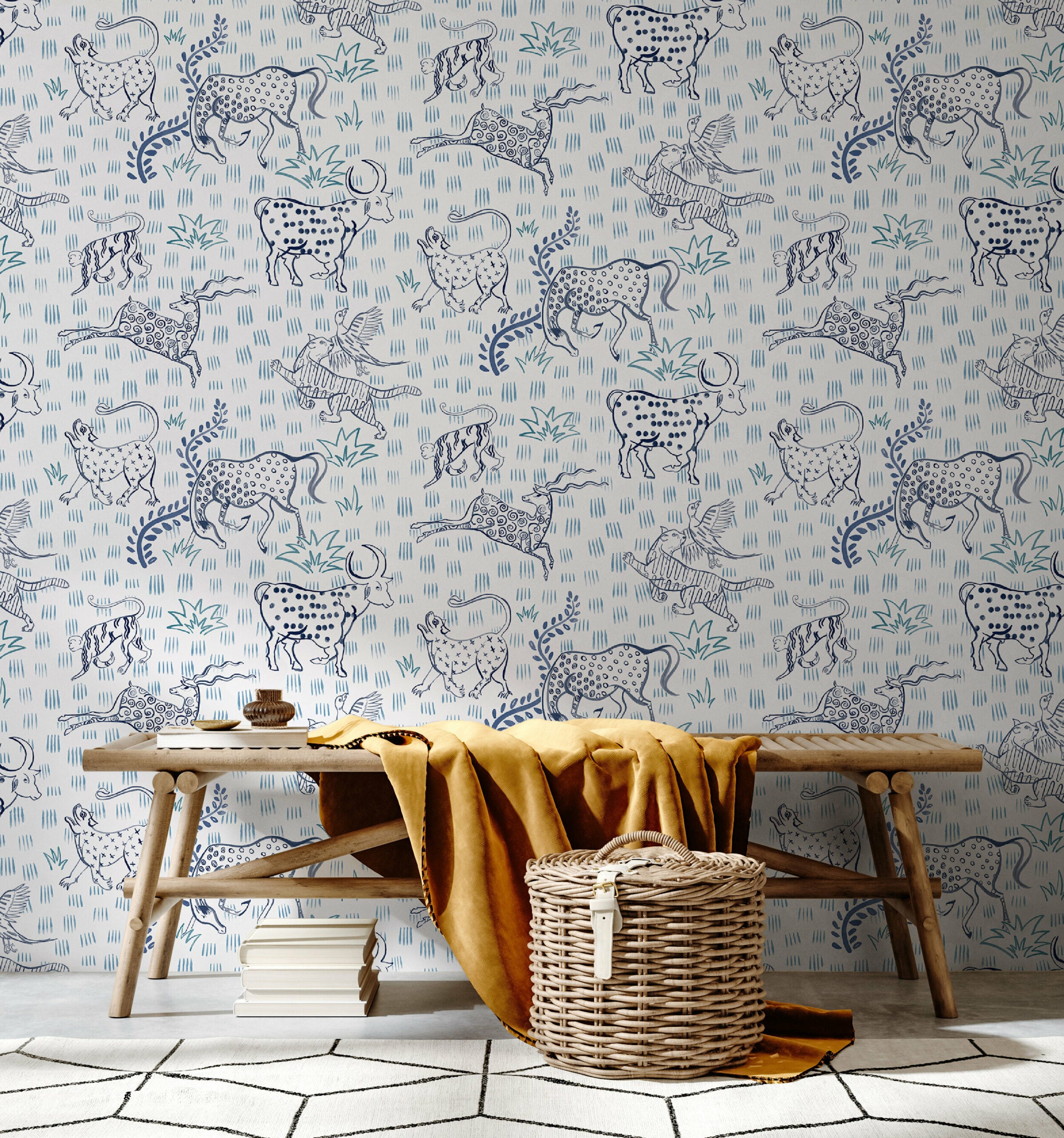 A bench and basket stand in front of a wall papered in a playful hand-drawn animal print in shades of blue on a white field.