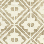 Detail of fabric in a geometric lattice grid in tan on a cream field.