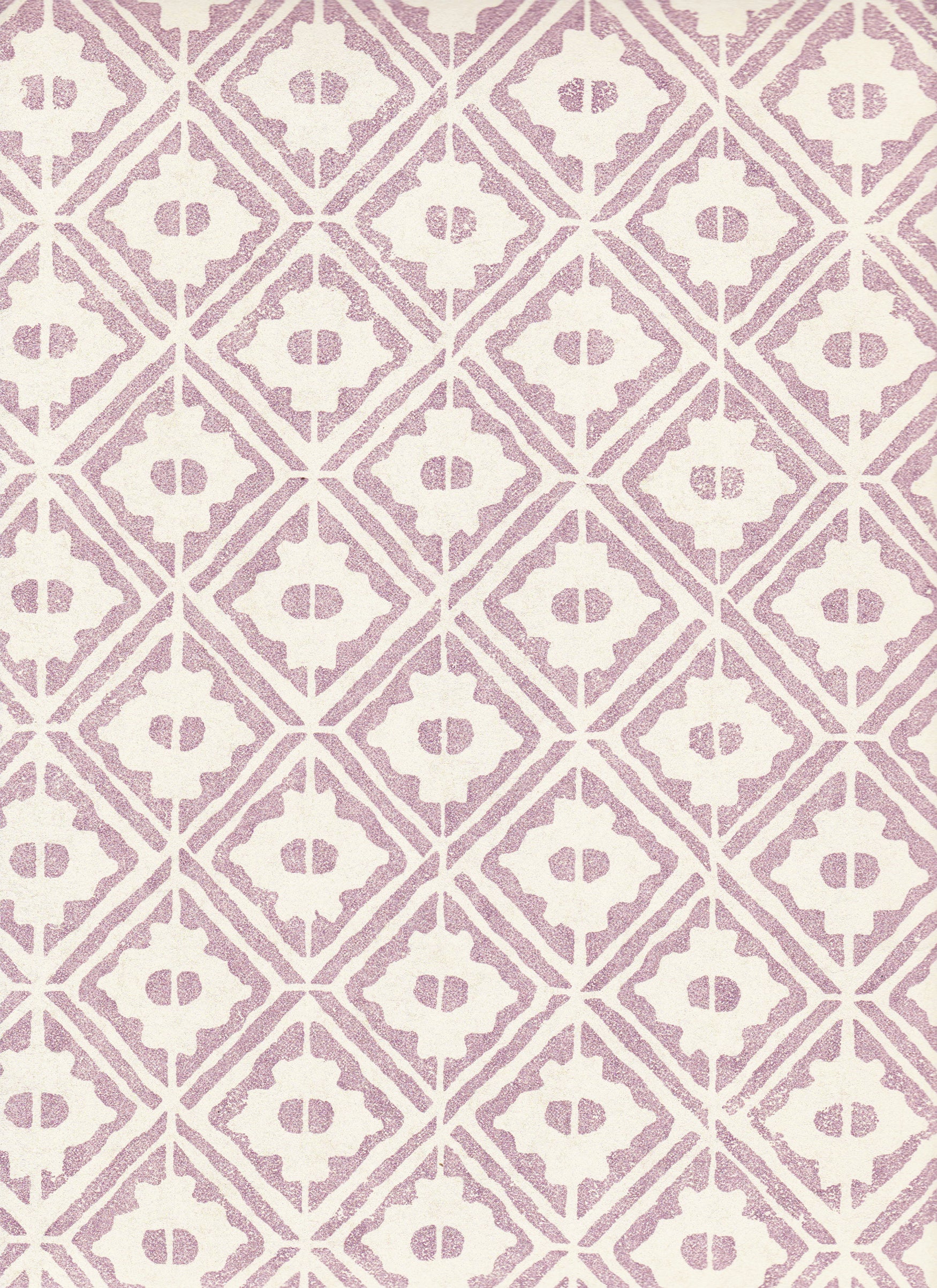 Detail of wallpaper in a geometric lattice print in purple on a cream field.