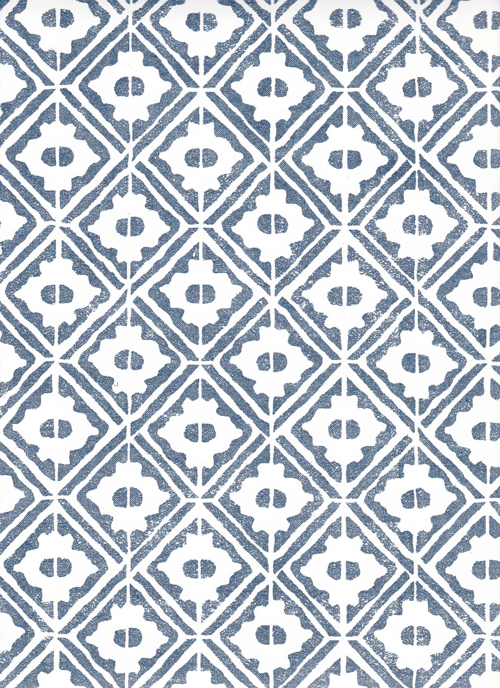 Detail of wallpaper in a geometric lattice print in navy on a white field.