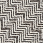 Detail - brown and ivory rug with a chevron pattern.