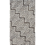 A brown and ivory rug with a chevron pattern.