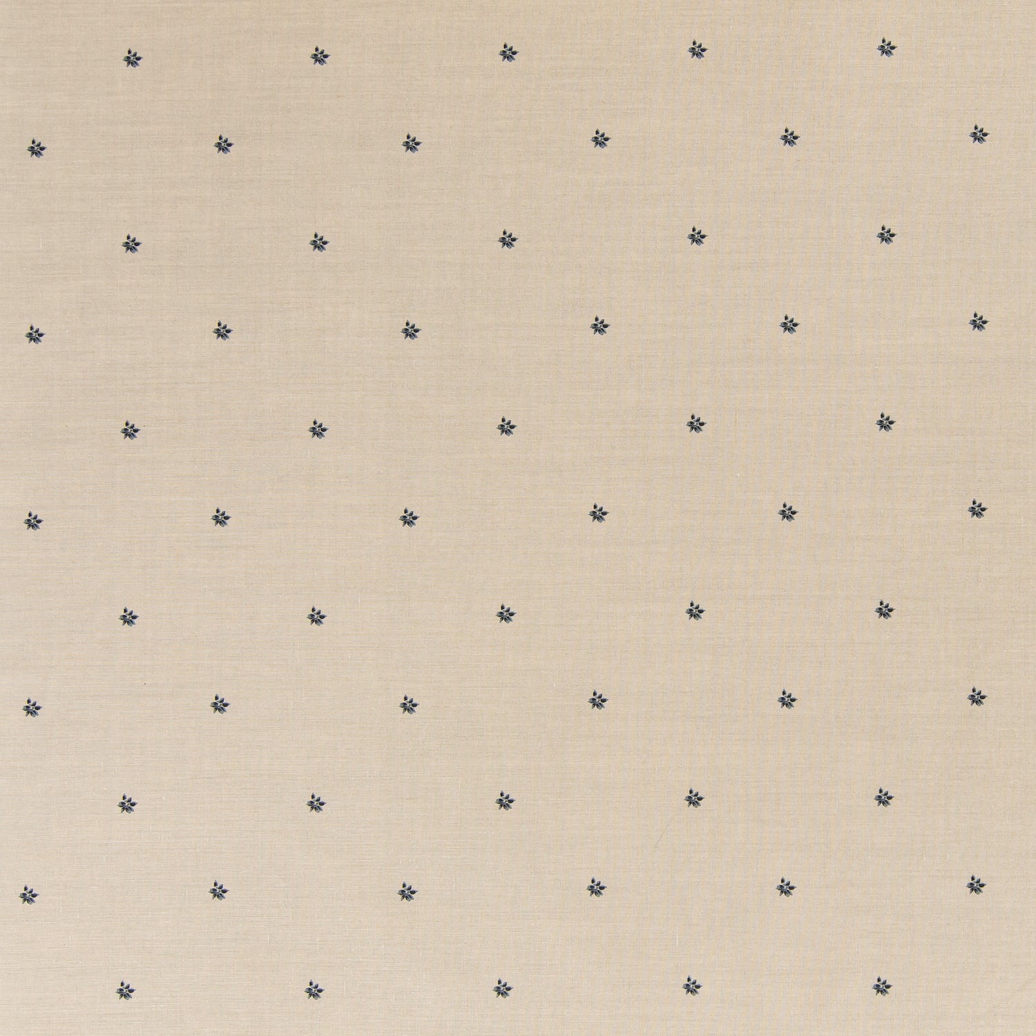 Printed linen fabric in a repeating small-scale flower pattern in navy on a cream field.