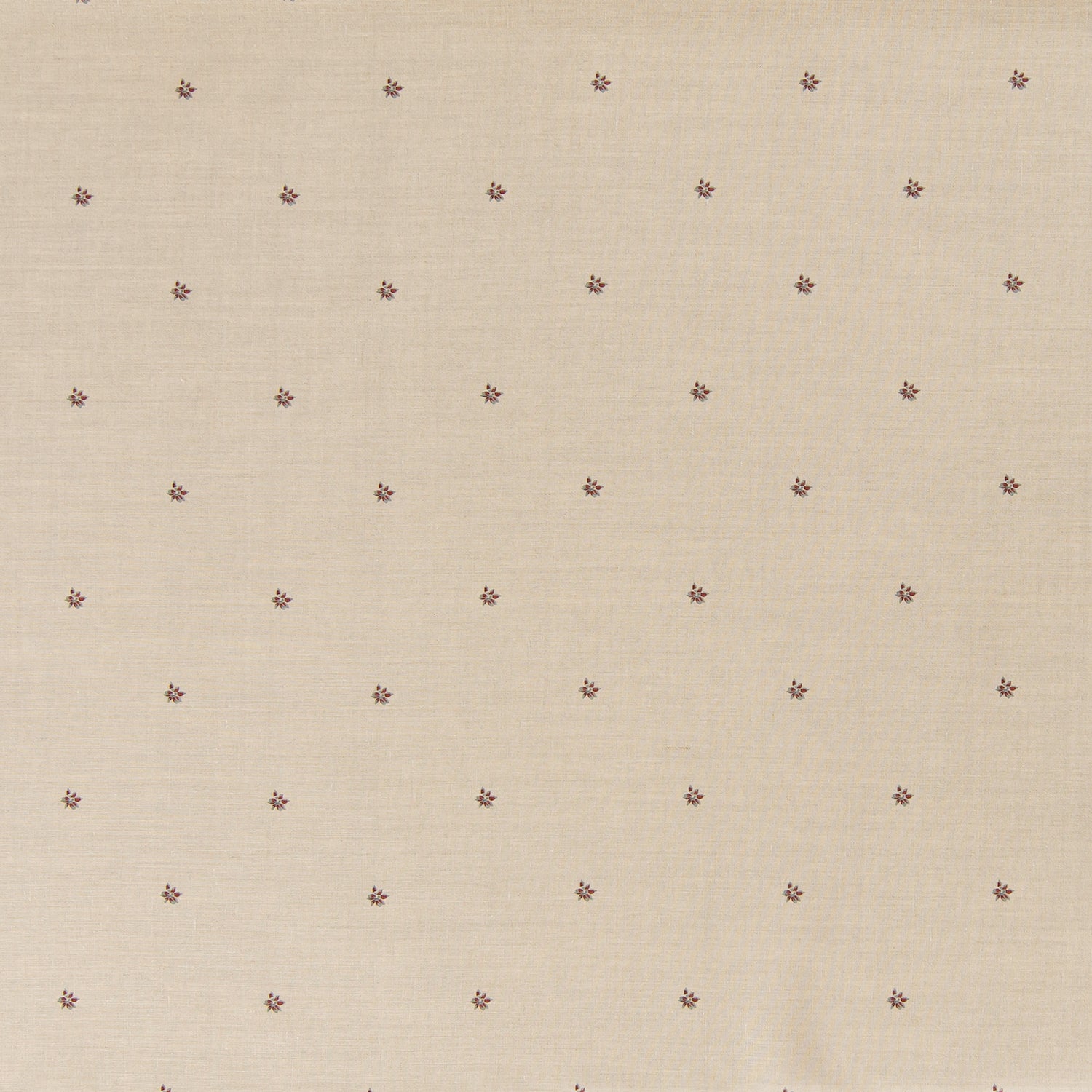 Printed linen fabric in a repeating small-scale flower pattern in red and gray on a cream field.