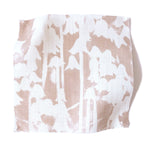 Square fabric swatch in a painterly bluebell pattern in white on a mottled blush field.