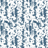 Detail of fabric in a painterly bluebell pattern in white on a mottled navy field.