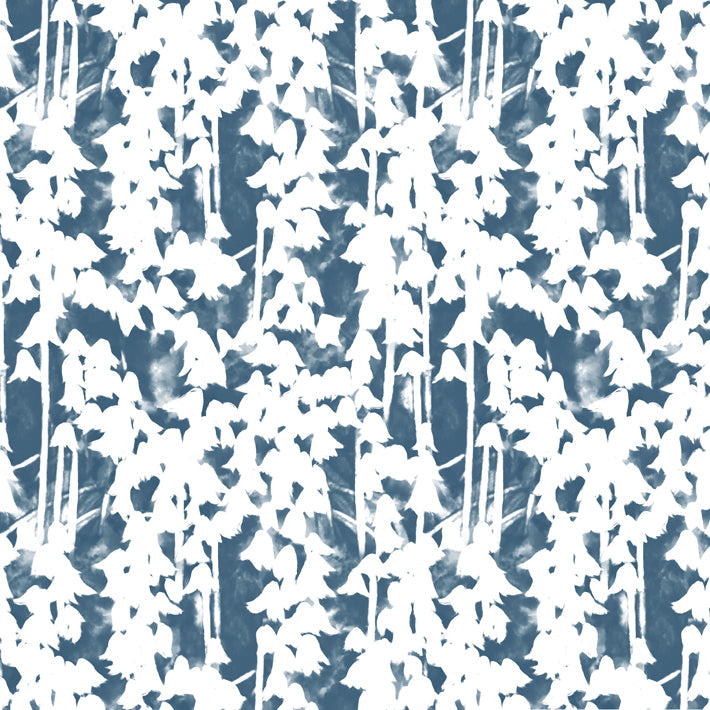 Detail of fabric in a painterly bluebell pattern in white on a mottled navy field.