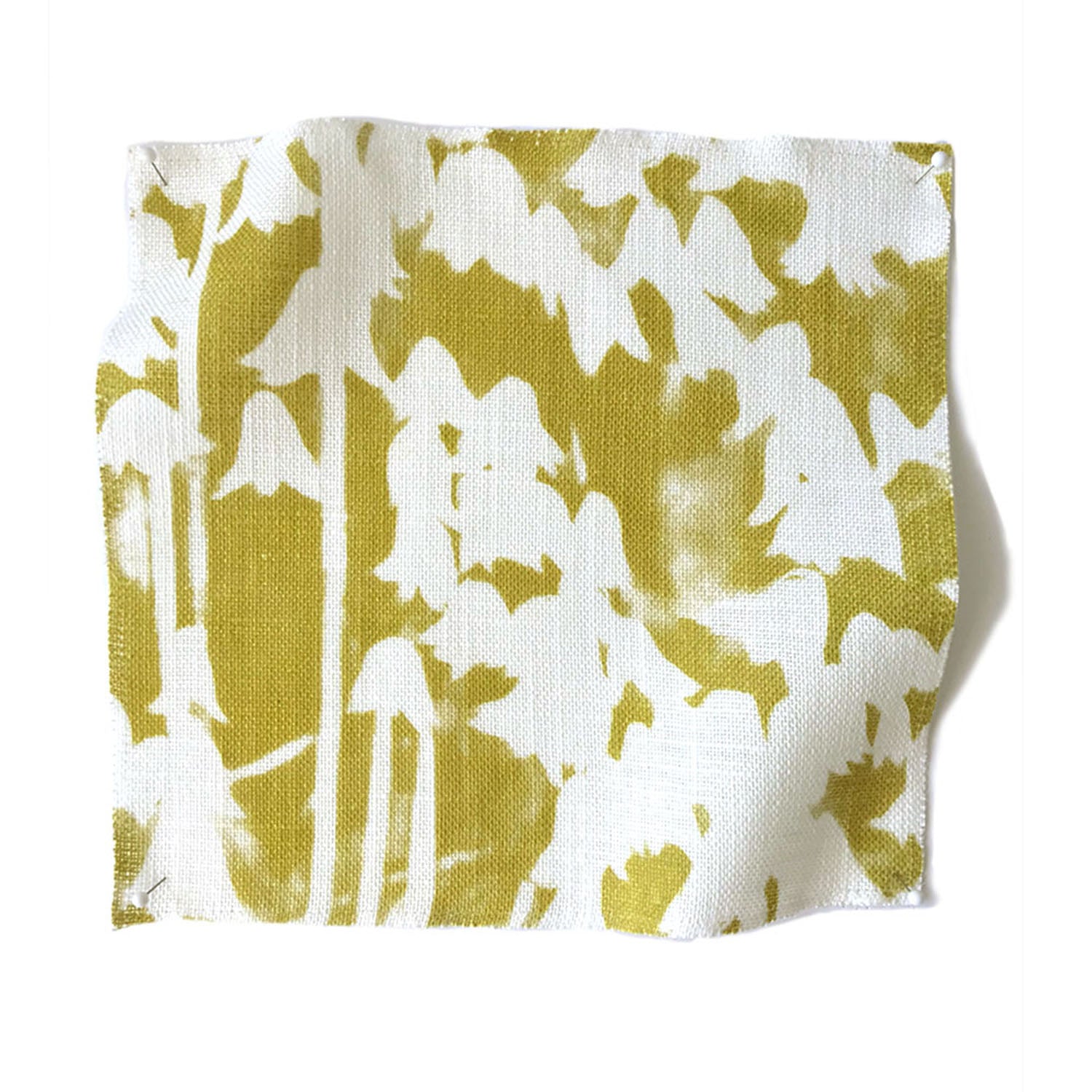 Square fabric swatch in a painterly bluebell pattern in white on a mottled mustard field.