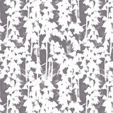 Detail of wallpaper in a painterly bluebell pattern in white on a mottled gray field.