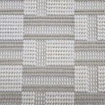 Broadloom carpet in a complex checkerboard pattern in ivory and pale taupe.