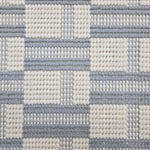 Broadloom carpet in a complex checkerboard pattern in ivory and light blue.