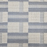 Broadloom carpet in a complex checkerboard pattern in ivory and light blue.