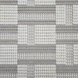 Broadloom carpet in a complex checkerboard pattern in ivory and light grey.