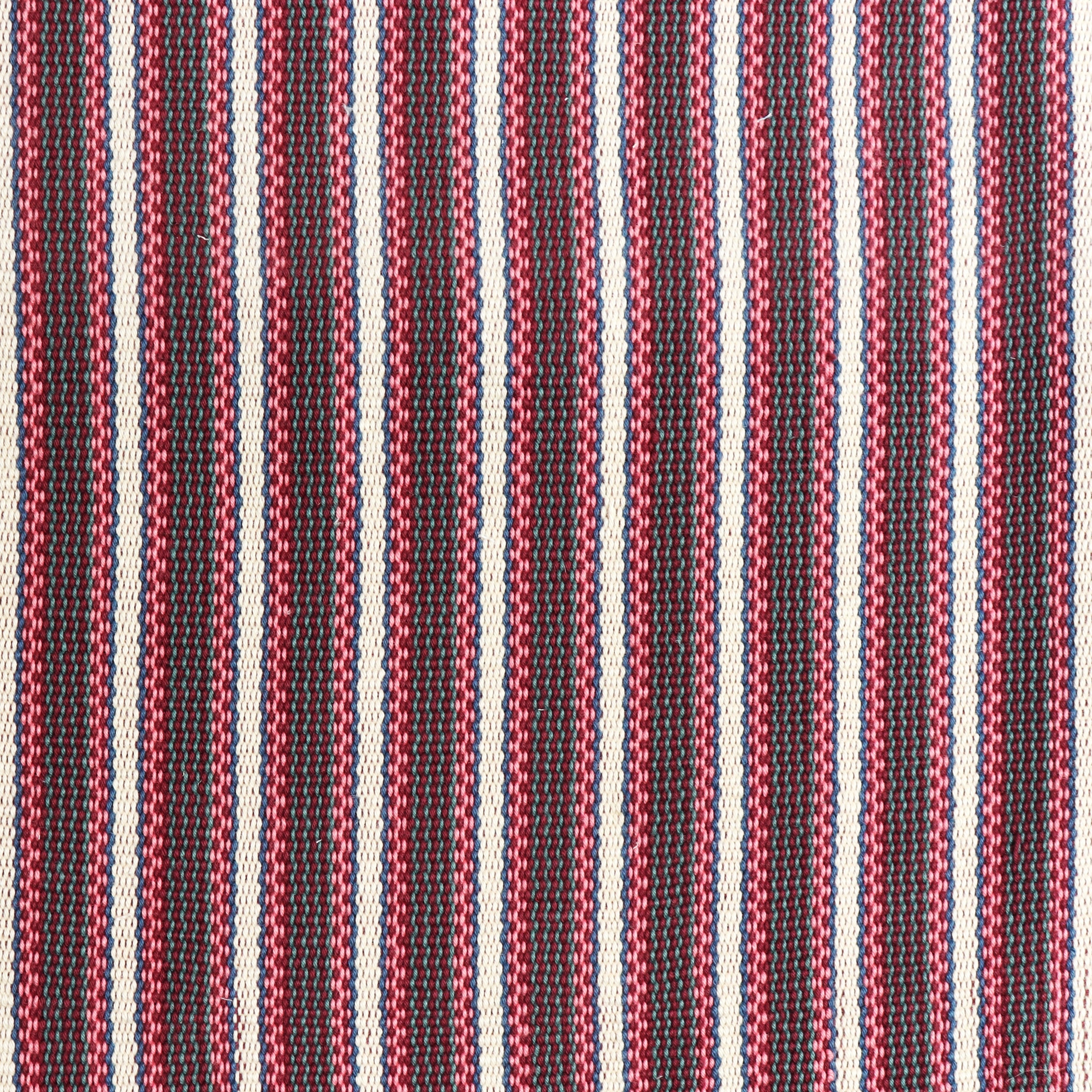 Detail of a hand-woven cotton fabric in an intricate stripe pattern in shades of pink, red, white and blue.