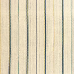 Detail of a hand-woven cotton fabric in an irregular stripe pattern in blue, yellow and green on a cream field.