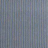 Detail of a hand-woven cotton fabric in a grid pattern in blue and tan.