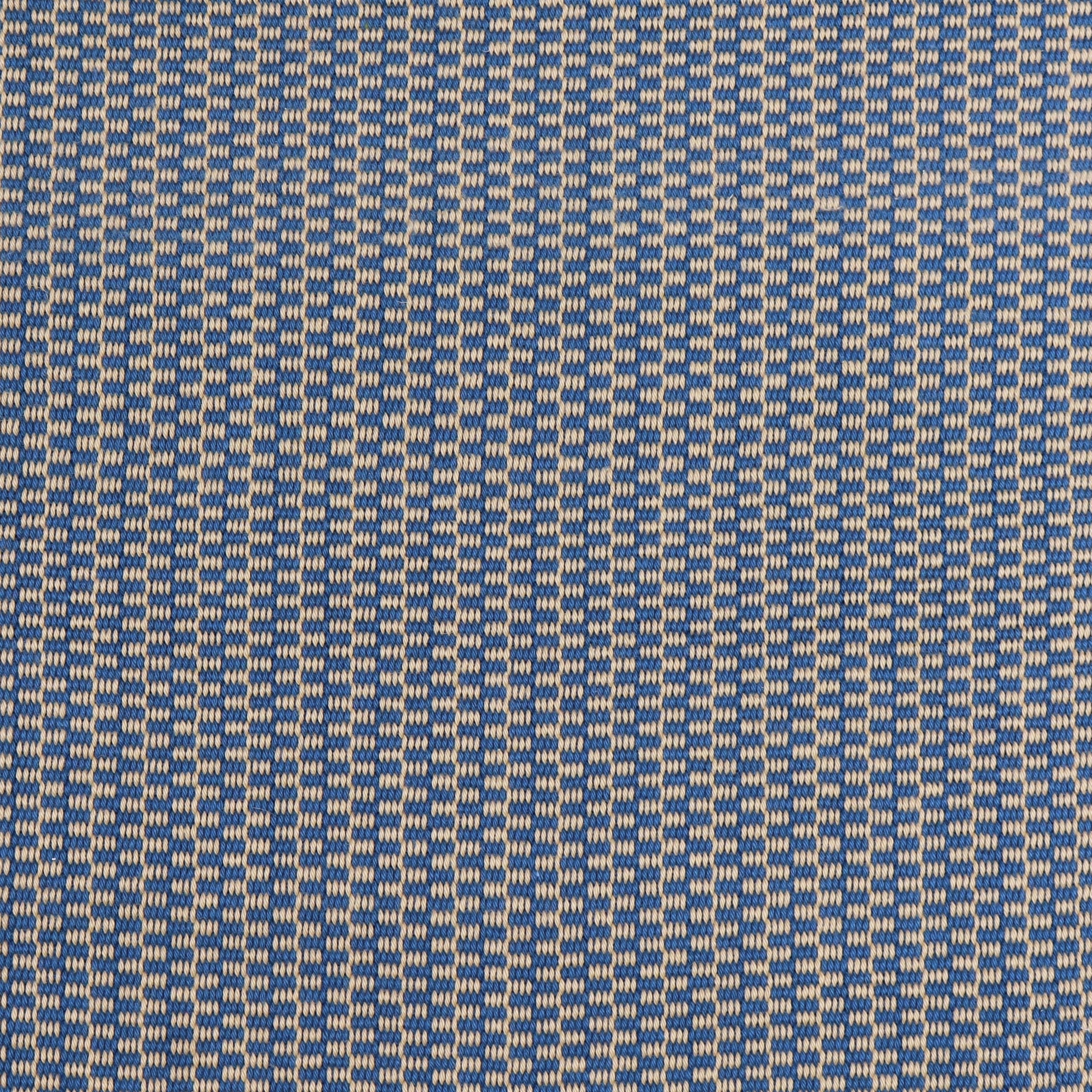 Detail of a hand-woven cotton fabric in a grid pattern in blue and tan.