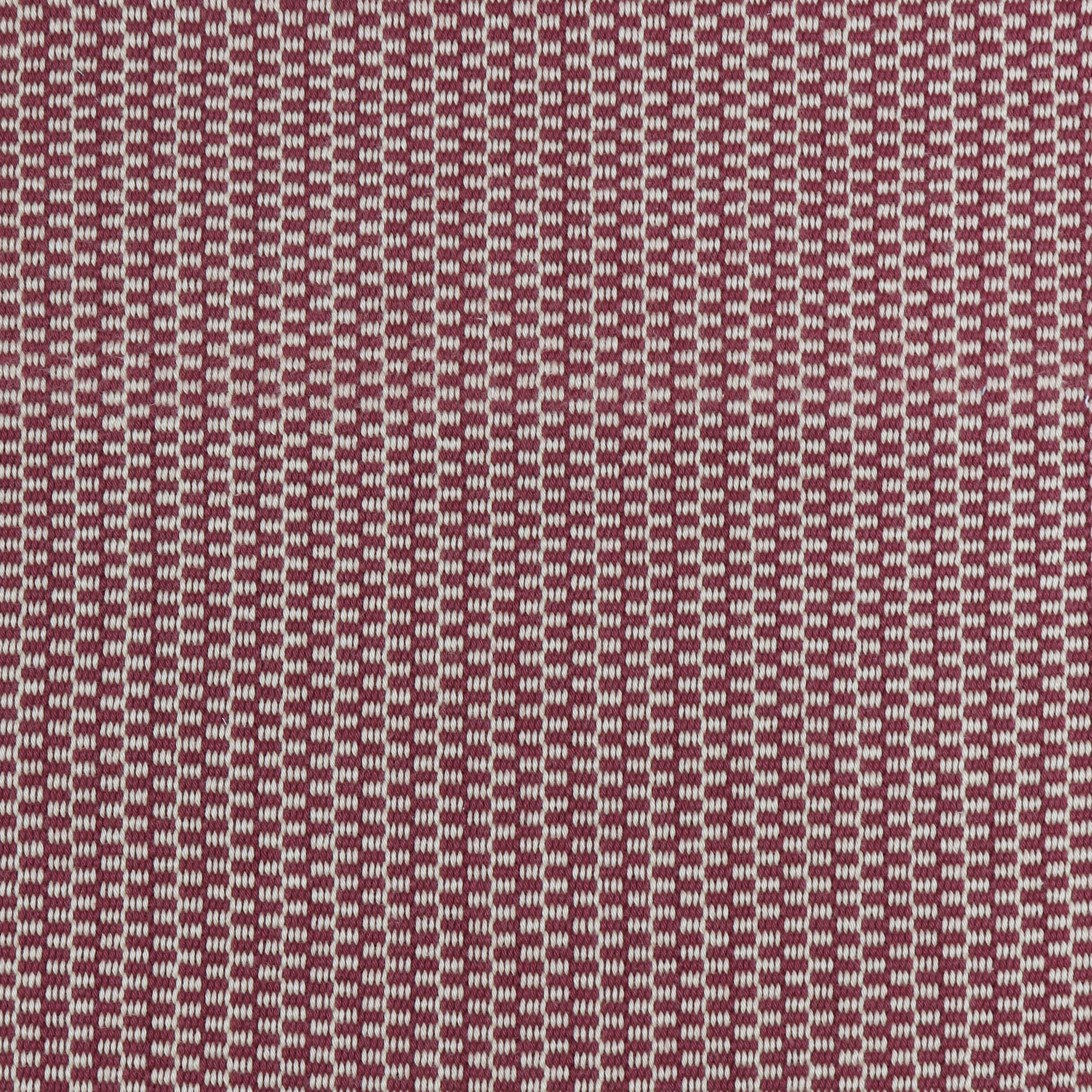 Detail of a hand-woven cotton fabric in a grid pattern in light gray and maroon.