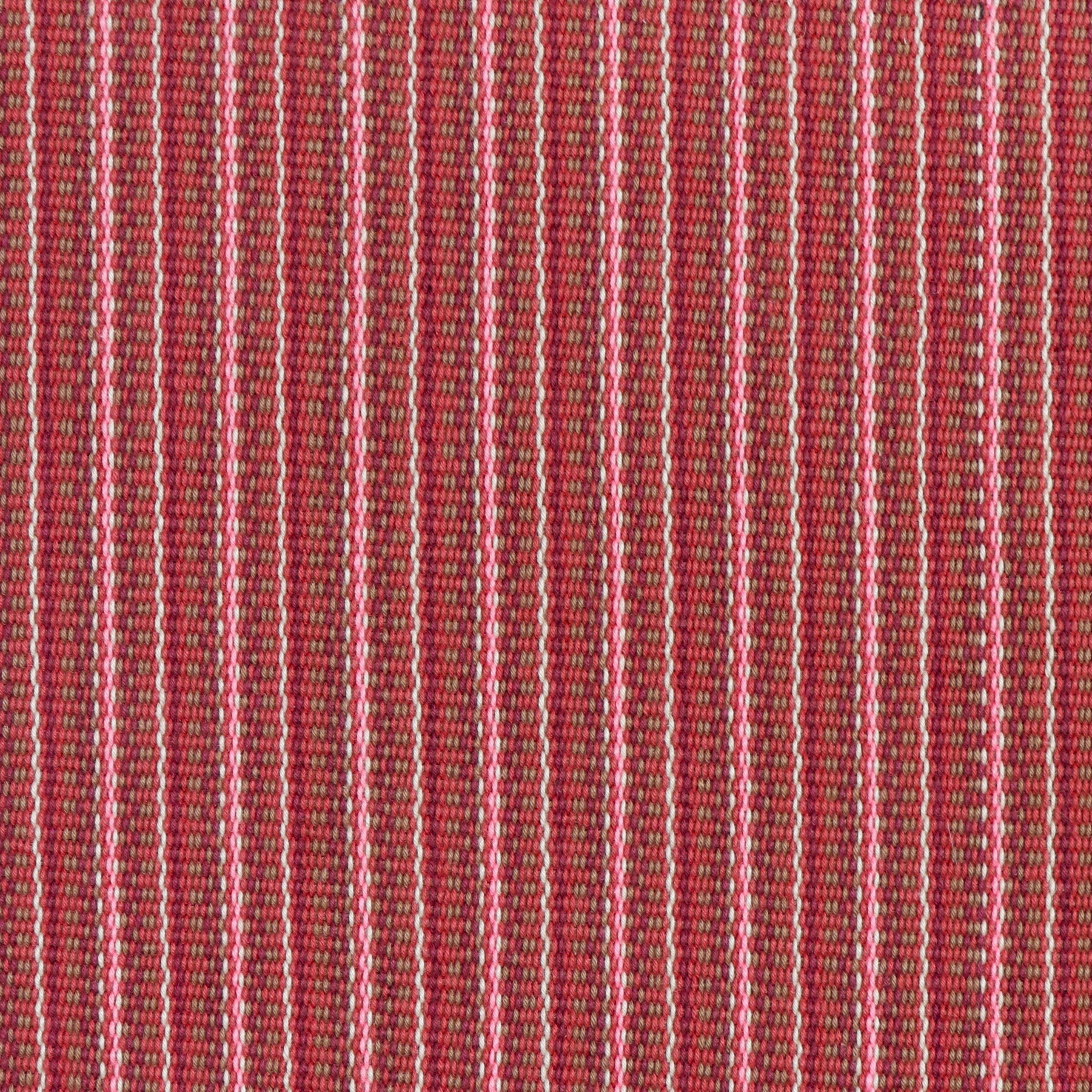 Detail of a hand-woven cotton fabric in an intricate stripe pattern in shades of pink, red and white.