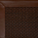 Close-up of woven leather rug with a wide leather binding in warm brown.